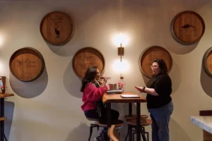 Kelci Wihera, right, speaks with a customer in the Local Vines tasting room in Lafayette. Don Feria For the S.F. Chronicle